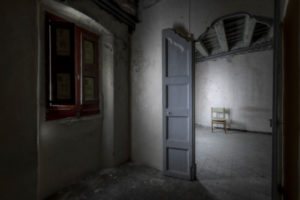 interior of an empty room with a chair and in a general state of abandonment in the city center of Barcelona in Catalonia Spain interior of an empty room with a chair and in a general state of abandonment in the city center of Barcelona in Catalonia Spain